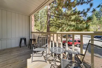 a porch with chairs and a table and a tree at 5 Mi to Northstar Skiing Bear Den Home with Decks in Kings Beach
