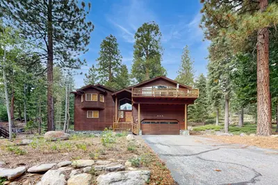 a log home with a deck in the woods at Vista Pines Retreat in Tahoe Vista
