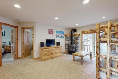 a bedroom with a bunk bed and a television in a room at Vista Pines Retreat in Tahoe Vista