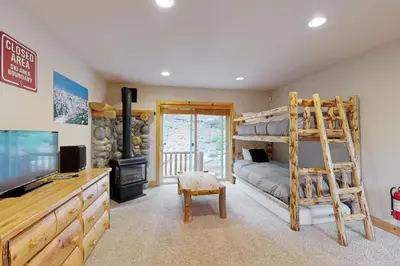 a bedroom with a bunk bed and a television in a room at Vista Pines Retreat in Tahoe Vista