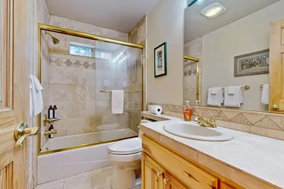 a bathroom with a sink and a tub and a toilet at Vista Pines Retreat in Tahoe Vista