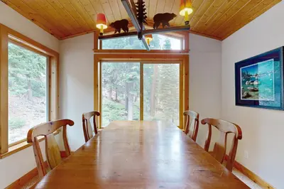 a dining room with a long table and chairs at Vista Pines Retreat in Tahoe Vista
