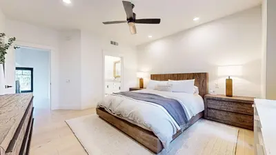 a bedroom with a bed and a ceiling fan at Timbers #12 townhouse in Mammoth Lakes