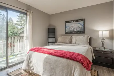 a bedroom with a bed and a large window at Crestview Bldg A #49 - Spacious 2 Bedroom, 2 Bathroom, Sleeps 7 - Close to Canyon Lodge and Village in Mammoth Lakes