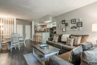 a living room with a couch and a table at Crestview Bldg A #49 - Spacious 2 Bedroom, 2 Bathroom, Sleeps 7 - Close to Canyon Lodge and Village in Mammoth Lakes