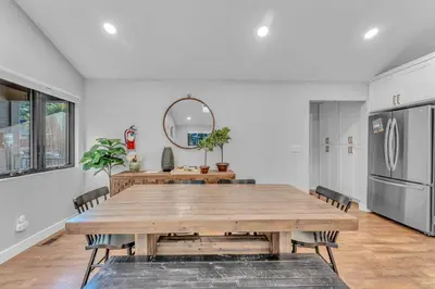 a dining room with a table and a refrigerator at Bright Tahoe Home with Private Backyard Near Beach in Tahoe City
