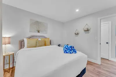 a white bedroom with a large white bed in it at Bright Tahoe Home with Private Backyard Near Beach in Tahoe City