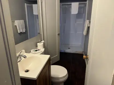 a bathroom with a sink and a toilet and a shower at Coalinga Motel in Coalinga
