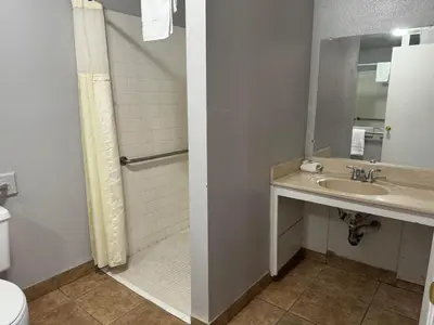 a bathroom with a sink and a shower at Coalinga Motel in Coalinga