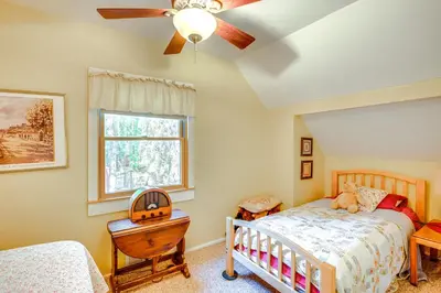 a bedroom with a bed and a ceiling fan at 1 Mi to Lake Tahoe Rustic Cabin with Boat Dock in Tahoma