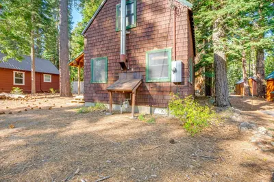 a house with a sign on the side of it at 1 Mi to Lake Tahoe Rustic Cabin with Boat Dock in Tahoma