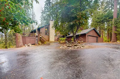 a house on a dirt road in front of a house at Tranquil Pines Retreat in Shaver Lake