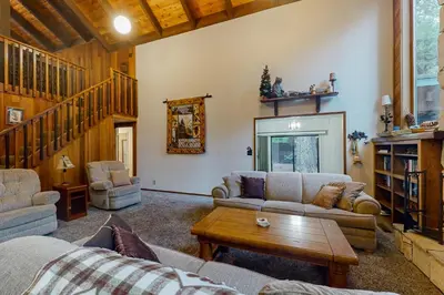 a living room with two couches and a table at Tranquil Pines Retreat in Shaver Lake