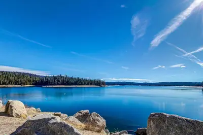 a view of a large blue lake with trees at Tranquil Pines Retreat in Shaver Lake