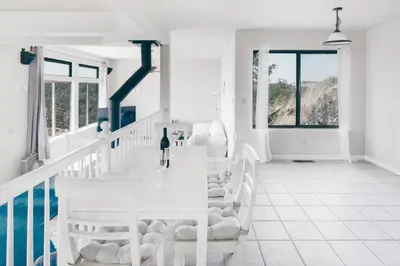 a white dining room with a white table and chairs at Breathtaking view of the Hills with HotTub, Pool and Pool Table in Marble Mountain