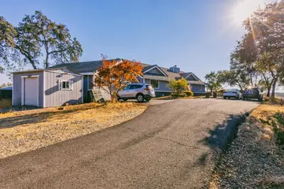 a house with cars parked on the side of a road at Breathtaking view of the Hills with HotTub, Pool and Pool Table in Marble Mountain