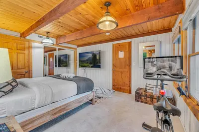 a bedroom with a bed and a bicycle in it at Modern Tahoe Retreat with Grill Walk to Beach in Homewood