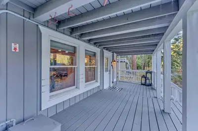 a front porch of a house with a wooden deck at Modern Tahoe Retreat with Grill Walk to Beach in Homewood