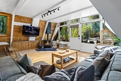 a living room with a couch and a table at The Sugar Pine Speakeasy in Homewood
