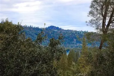 a view of a mountain with trees and a lake at Mountain Dimension in Ponderosa Basin