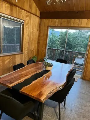 a wooden table in a room with chairs around it at Mountain Dimension in Ponderosa Basin