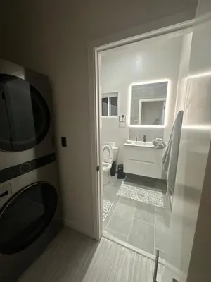 a bathroom with a toilet and a tub and a sink at Muniz Village in Three Rivers