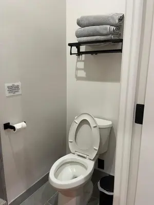 a small bathroom with a toilet and some towels at Muniz Village in Three Rivers