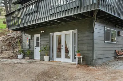 a small house with a white door and a balcony at Sequoia TREE HOUSE light andbright in Three Rivers