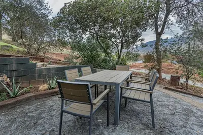 a wooden table with two chairs sitting around it at Sequoia TREE HOUSE light andbright in Three Rivers