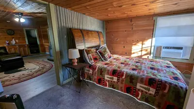 a bedroom with a bed and a lamp on a table at Baltyr Cabin in Miramonte