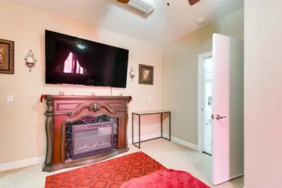 a living room with a fireplace with a flat screen tv on the wall at 10 Mi to Yosemite Lake Atwater Retreat in Atwater