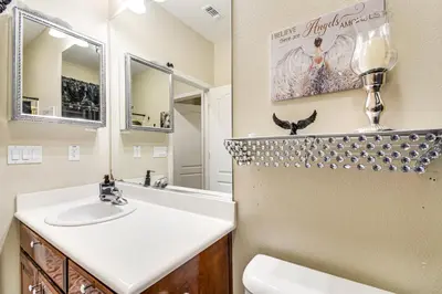 a bathroom with a sink and a mirror at 10 Mi to Yosemite Lake Atwater Retreat in Atwater