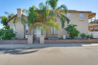 a house with palm trees in front of it at 10 Mi to Yosemite Lake Atwater Retreat in Atwater