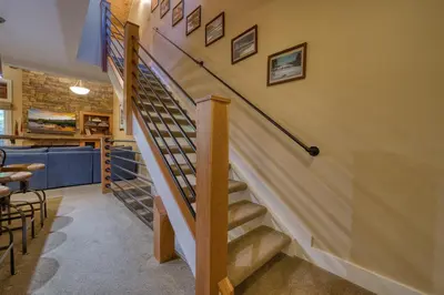 a staircase leading up to a room with a bar at Carnelian Woods # 57 - 3 BR 2 BA Pet Friendly With HOA Amenities in Carnelian Bay