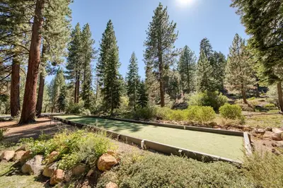 a tennis court in a forest with trees at Carnelian Woods # 57 - 3 BR 2 BA Pet Friendly With HOA Amenities in Carnelian Bay