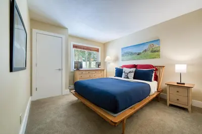 a bedroom with a bed with blue and red pillows at Carnelian Woods # 57 - 3 BR 2 BA Pet Friendly With HOA Amenities in Carnelian Bay