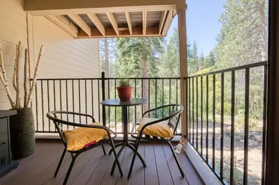 a patio with two chairs and a table on a porch at Carnelian Woods # 57 - 3 BR 2 BA Pet Friendly With HOA Amenities in Carnelian Bay