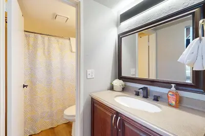 a bathroom with a sink and a mirror and a toilet at Keys to Paradise in South Lake Tahoe