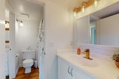 a bathroom with a sink and a toilet and a mirror at Keys to Paradise in South Lake Tahoe