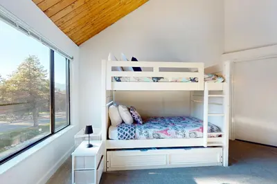 a bedroom with bunk beds and a window at Keys to Paradise in South Lake Tahoe