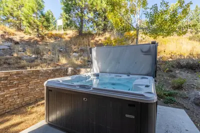 a hot tub sitting on top of a patio at Mammoth Gateway Village #1 - Highly Updated Townhome - Walk To Village 3 Bed+Loft, Sleeps 10 in Mammoth Lakes