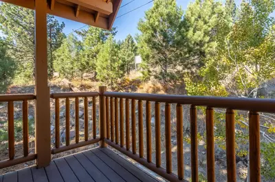 a balcony with a view of the woods at Mammoth Gateway Village #1 - Highly Updated Townhome - Walk To Village 3 Bed+Loft, Sleeps 10 in Mammoth Lakes