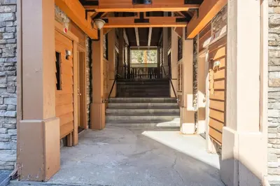an empty hallway of a building with stairs at Mammoth Gateway Village #1 - Highly Updated Townhome - Walk To Village 3 Bed+Loft, Sleeps 10 in Mammoth Lakes