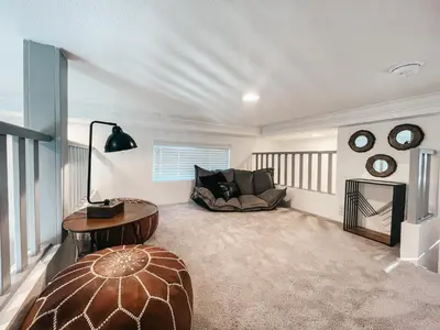 a living room with a couch and a table at Beautiful Downtown Cottage Onyx in Reno