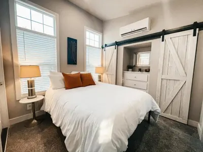 a bedroom with a white bed and a window at Beautiful Private Cottage Sunstone in Reno
