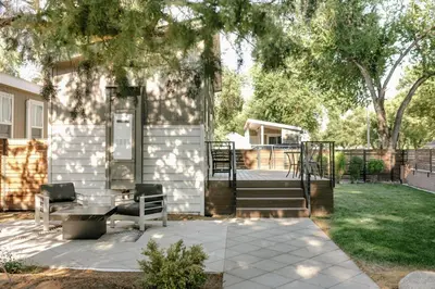 a patio with two chairs and stairs next to a house at Beautiful Cottage on Historic Grounds in Reno