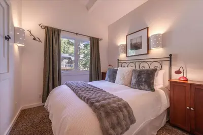 a bedroom with a large bed and a window at Cozy Palisades Tahoe Ski Cabin 3BR 3BA Free Shuttle to Lifts Book on Mobile for Promo Price in Alpine Meadows