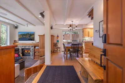 a kitchen and living room with a table and a dining room at Cozy Palisades Tahoe Ski Cabin 3BR 3BA Free Shuttle to Lifts Book on Mobile for Promo Price in Alpine Meadows