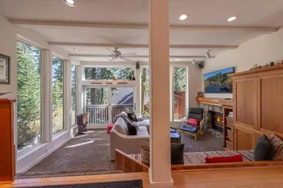 a living room with a couch and a table at Cozy Palisades Tahoe Ski Cabin 3BR 3BA Free Shuttle to Lifts Book on Mobile for Promo Price in Alpine Meadows