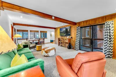 a living room with a green couch and chairs at Northstar Retreat with Hot Tub & FREE Shuttle Access in Truckee